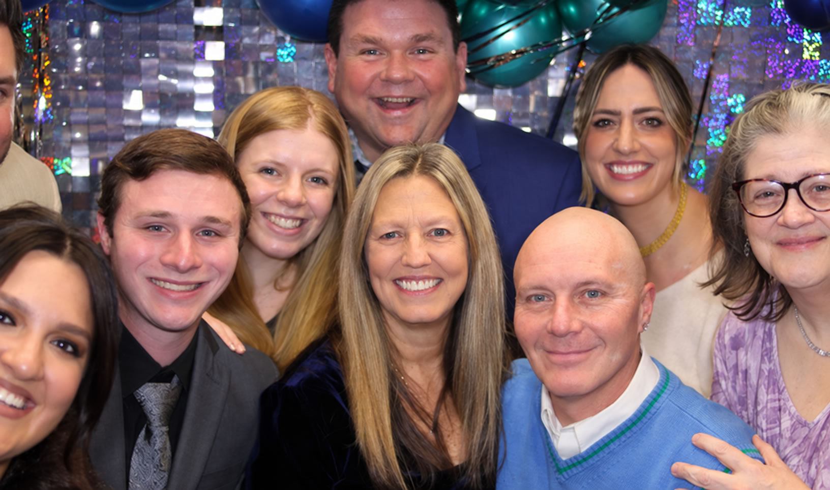 A large group of adults smiling together at an organization event
